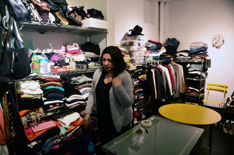 Volunteer Jenny Tapia, 42, works at a "boutique" that gives away donated crisp business clothes to those who on Mexico's September 19 quake lost everything but their jobs, in Mexico City's Roma neighbourhood on October 16, 2017