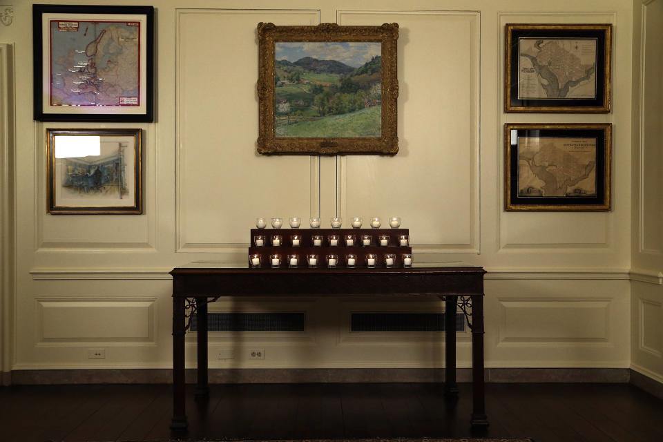 Twenty-six candles remain lit after Obama and the first lady observed a moment of silence in memory of the 20 children and six school workers killed by a gunman at Sandy Hook Elementary School one year ago, in the Map Room at the White House in Washington