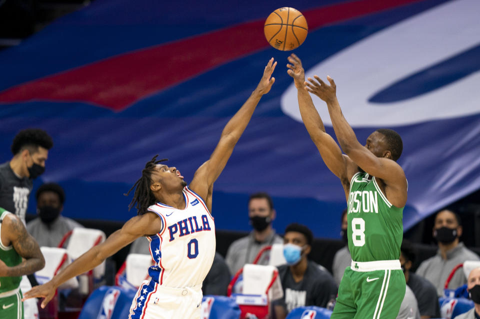 Boston Celtics guard Kemba Walker, right, shoots a 3-pointer over Philadelphia 76ers guard Tyrese Maxey during the first half of an NBA basketball game Wednesday, Jan. 20, 2021, in Philadelphia. (AP Photo/Chris Szagola)