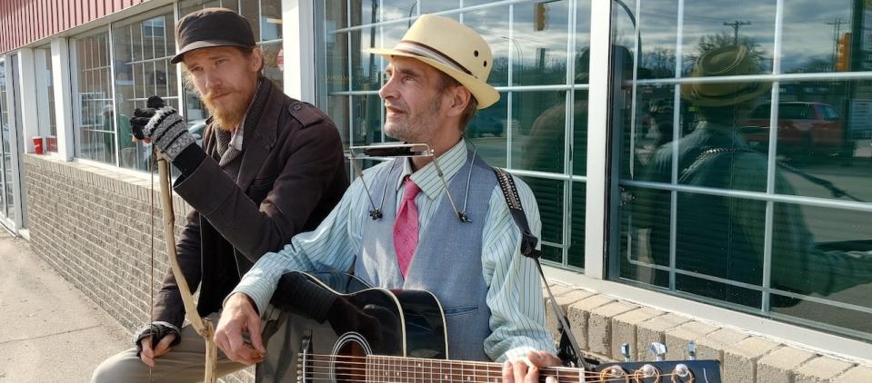 $2 Bill busking on a street corner.