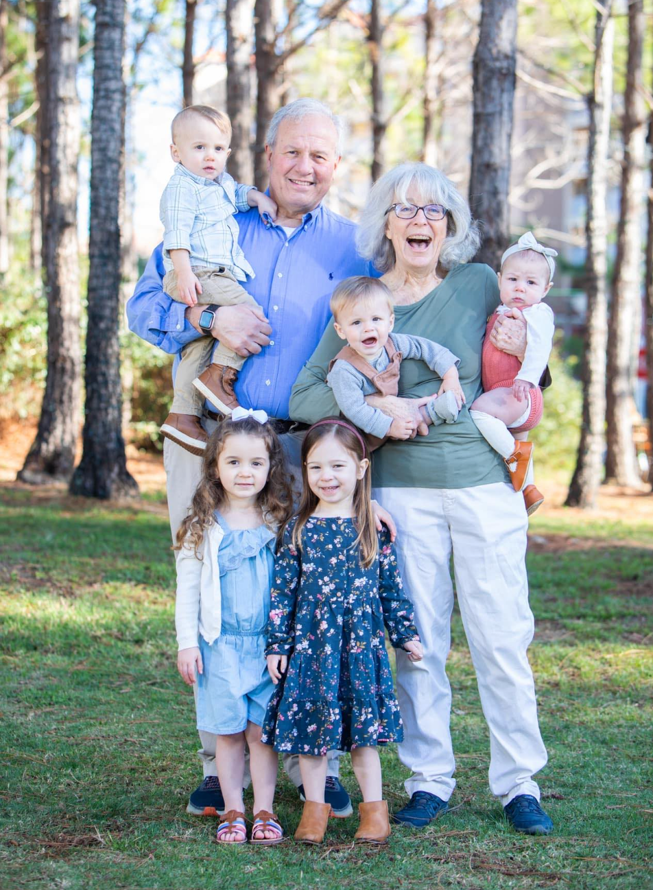 Steve DiMeo, the president of Mohawk Valley EDGE until his death on March 6, 2024, and his wife Dianne pose with their five grandchildren.