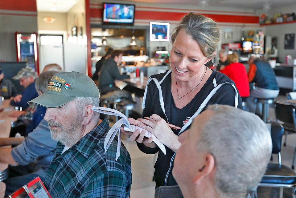 Waitress Christine Dunn, of Marshfield, takes the lunch orders of 17 veterans at the Brant Rock Hop in Marshfield on Tuesday, Jan. 10, 2023.