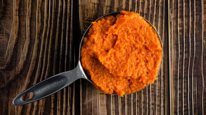 Pumpkin puree in measuring cup