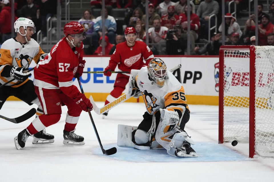 Detroit Red Wings left wing David Perron (57) scores on Pittsburgh Penguins goaltender Tristan Jarry (35) in the second period of an NHL hockey game Wednesday, Oct. 18, 2023, in Detroit. (AP Photo/Paul Sancya)