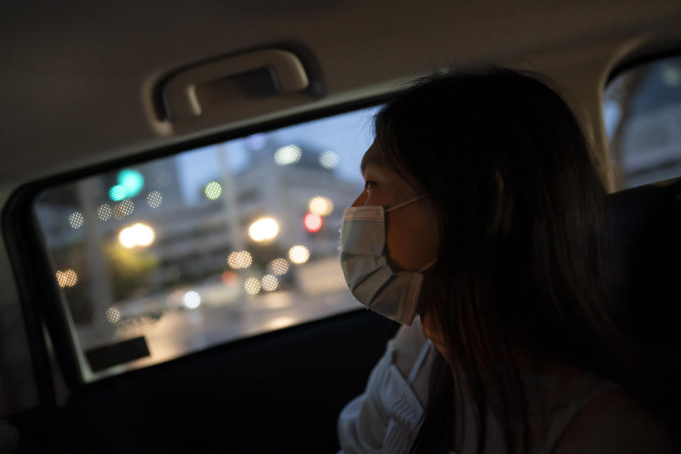 Lune Loh, 25, a transgender woman, rides in a car to attend an open mic night for poets in Singapore, on Thursday, Aug. 18, 2022. Poetry has long been a lifeline for Loh. In between military exercises, she often lay in her bunk, typing poems into her phone. After her shifts, she put on makeup and a wig and went to open mic nights around the city that drew members of the LGBTQ community. (AP Photo/Wong Maye-E)