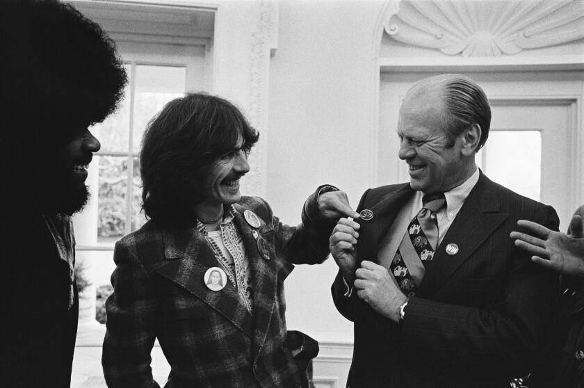 WASHINGTON DC - DECEMBER 13: (NO U.S. TABLOID SALES) Former Beatle George Harrison and keyboardist Billy Preston meet President Gerald Ford in the Oval Office December 13, 1974 in Washington DC. Harrison put on a WIN button (for Ford's "Whip Inflation Now"program), and gave the president a pin with the sacred Sanskrit "om" symbol. (Photo by David Hume Kennerly/Getty Images)