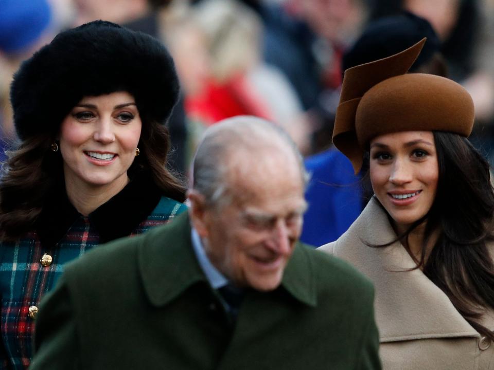 Catherine, Duchess of Cambridge, Britain's Prince Philip, Duke of Edinburgh and US actress and fiancee of Britain's Prince Harry Meghan Markle (R) arrive to attend the Royal Family's traditional Christmas Day church service at St Mary Magdalene Church in Sandringham, Norfolk, eastern England, on December 25, 2017.