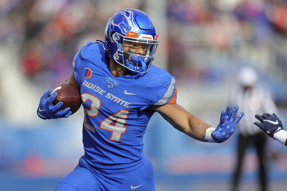 FILE - Boise State running back George Holani (24) runs with the ball against Utah State in the second half of an NCAA college football game, Nov. 25, 2022, in Boise, Idaho. It’s been four years since Boise State last claimed a Mountain West championship. That might not seem like much of a drought, but for the Broncos it’s been a frustrating stretch of missed chances at the conference crown. (AP Photo/Steve Conner, File)