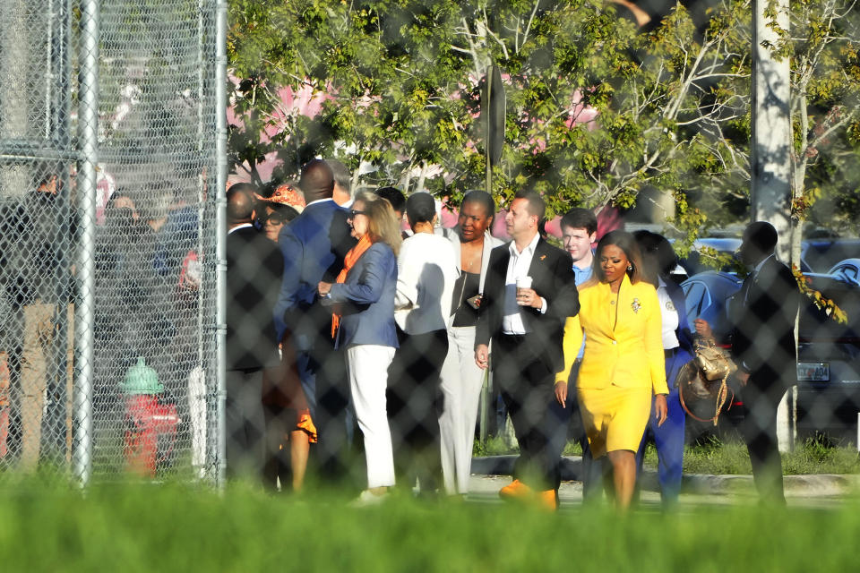 Nine members of Congress and others enter Marjory Stoneman Douglas High School, Friday, Aug. 4, 2023, in Parkland, Fla. The group will tour the blood-stained and bullet-pocked halls, shortly before ballistics technicians reenact the massacre that left 14 students and three staff members dead in 2018. The reenactment is part of a lawsuit filed by the victims' families against former Deputy Scot Peterson and the Broward Sheriff's Office. (AP Photo/Marta Lavandier)