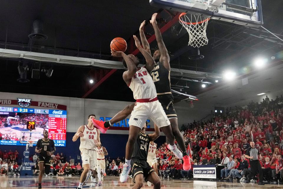 Florida Atlantic guard Johnell Davis (1) drives to the basket Sunday as UAB guard Tony Toney (12) defends during the first half in Boca Raton. Davis led all scorers with 30 points.