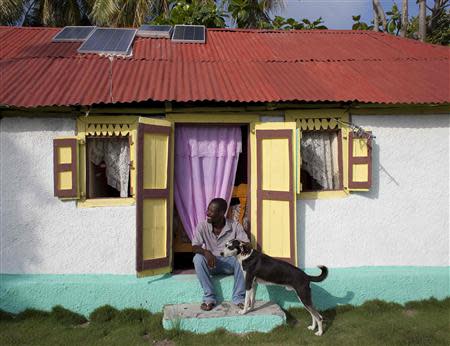 Jerome Genest, one of the leaders of the opposition to the government's proposal to turn their island into a tourist haven, sits in front of his home on Ile-a-Vache island, off Haiti's south coast, March 26, 2014. REUTERS/stringer