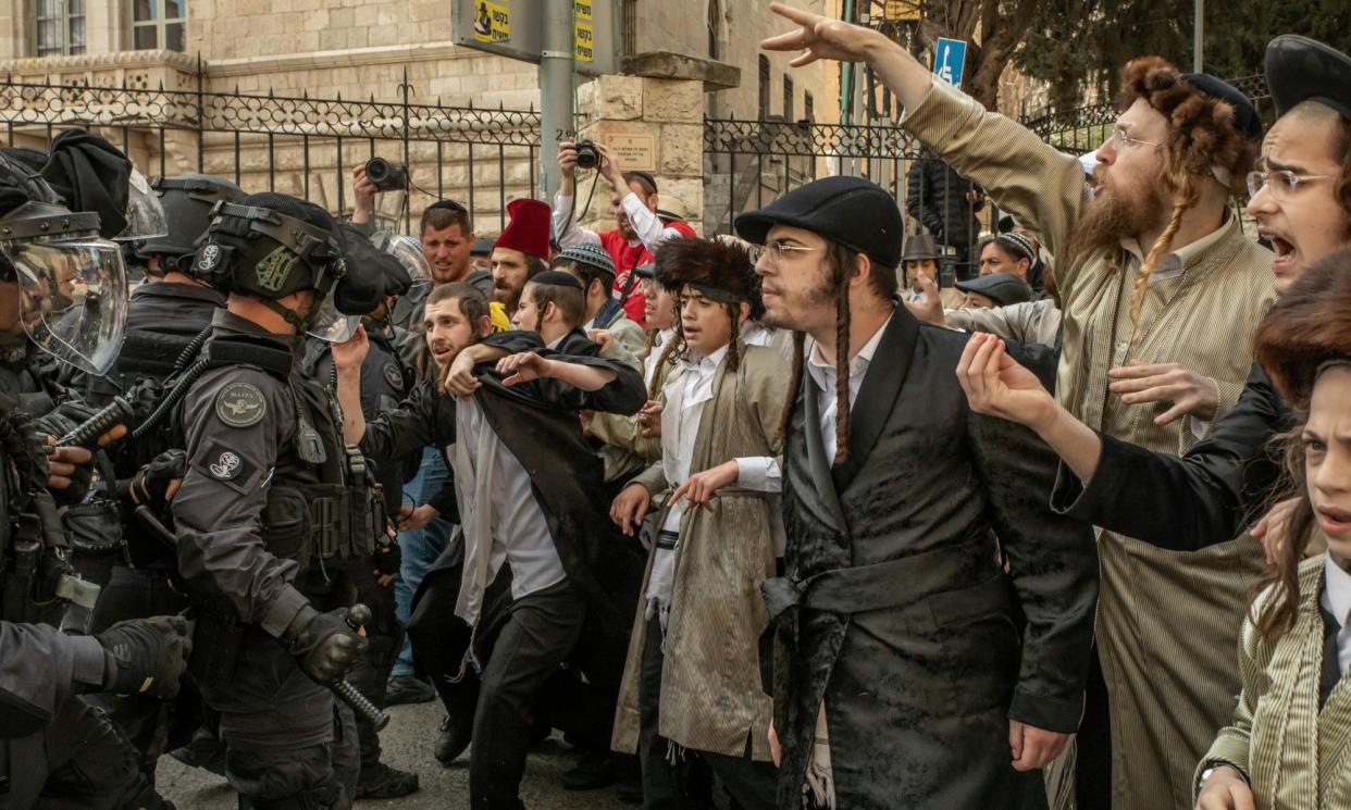 <span>Ultra-Orthodox young men clash with police in Jerusalem during a protest against the plans.</span><span>Photograph: Alessio Mamo/The Guardian</span>