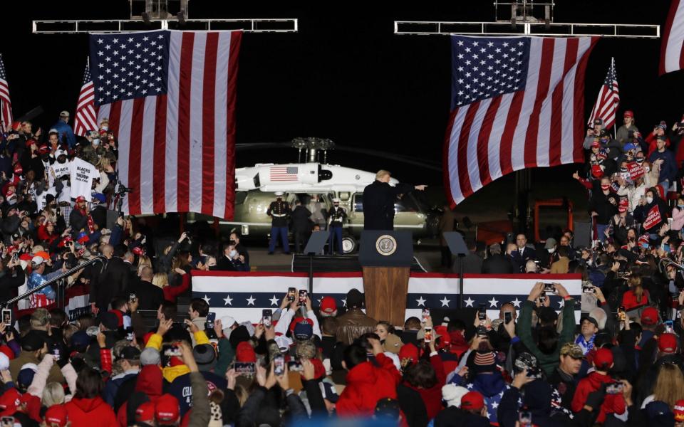 US President Donald J. Trump gestures as he departs after participating in an election eve campaign rally  - EPA