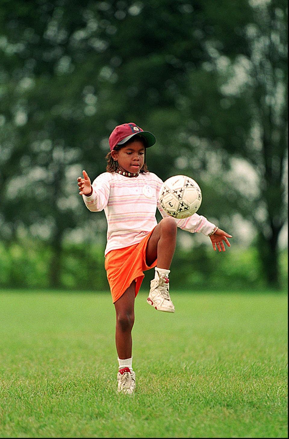 Hydeia Broadbent, 11, who is HIV positive, plays soccer at Camp Heartland in Woodstock, Ill.