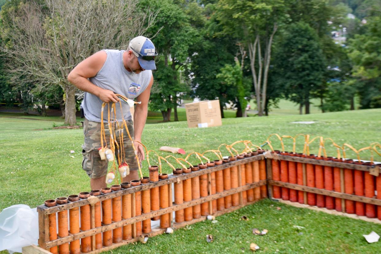 Pyrotechnician Chris Layman prepares the opener for the Happy Birthday America fireworks show on July 4, 2019.