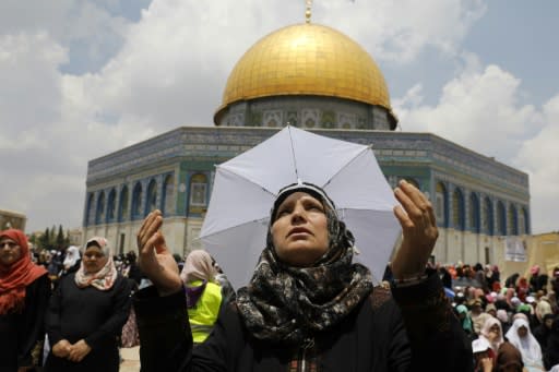 A Palestinian woman prays near the Dome of the Rock in Jerusalem on the third Friday prayers of the Islamic holy month of Ramadan on June 1, 2018