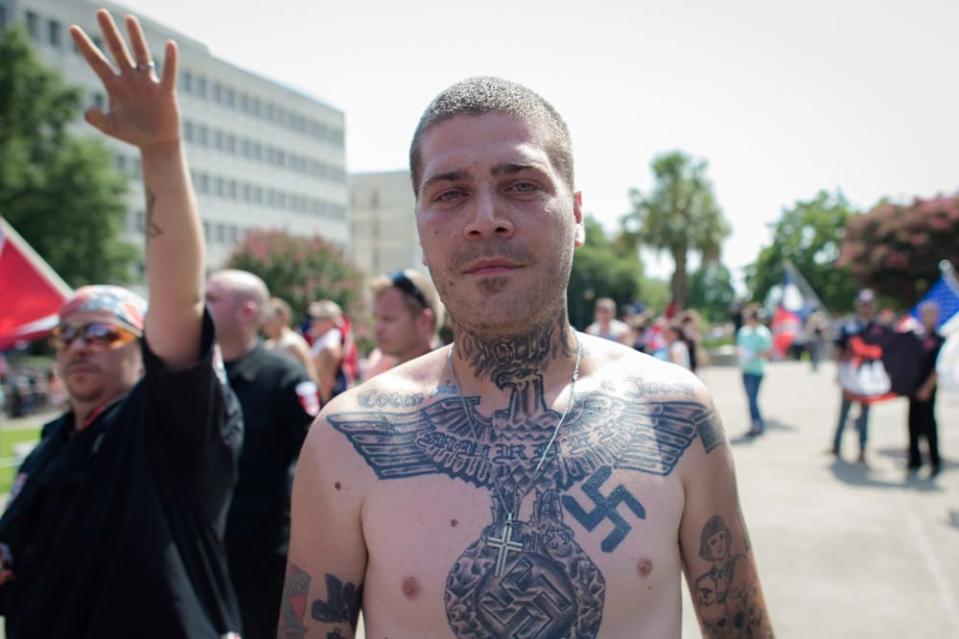 <div class="inline-image__caption"><p>"A man with a Swastika tattoo faces a large group of angry protestors during Ku Klux Klan sponsored rally at the South Carolina State House in Columbia, South Carolina."</p></div> <div class="inline-image__credit">Courtesy Anthony S. Karen</div>