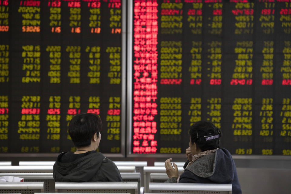 In Monday, Nov. 11, 2019, photo, investors monitor stock prices at a brokerage in Beijing. Shares were mixed in Asia on Tuesday, Nov. 12, as investors awaited cues on trade talks between China and the U.S. (AP Photo/Ng Han Guan)