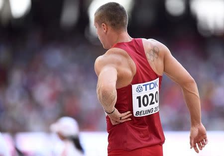 Trey Hardee of the U.S. is injured after an attempt in the long jump event of the men's decathlon during the 15th IAAF World Championships at the National Stadium in Beijing, China, August 28, 2015. REUTERS/Dylan Martinez