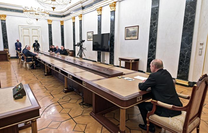 Russian President Vladimir Putin, right, leads a meeting on on economic issues in Moscow, Russia, Monday, Feb. 28, 2022. (Alexei Nikolsky, Sputnik, Kremlin Pool Photo via AP)