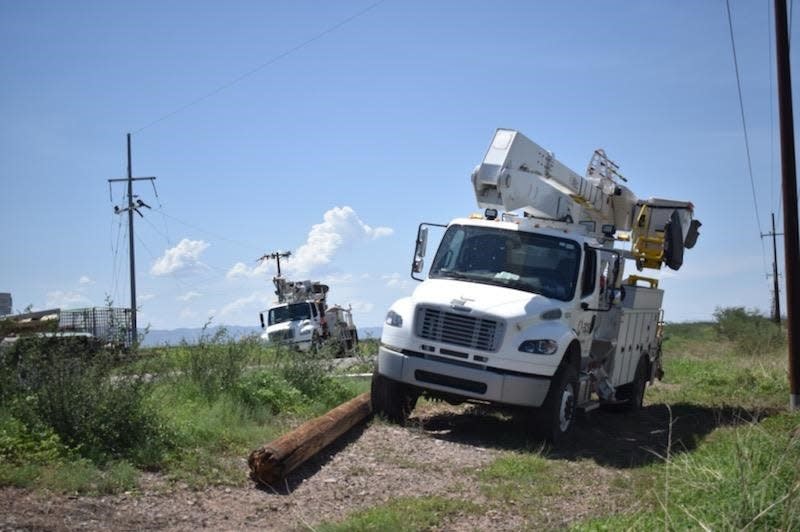 APS workers restringing wire across the road on highway 191 and Leake Road in Douglas after a storm caused major power outages.