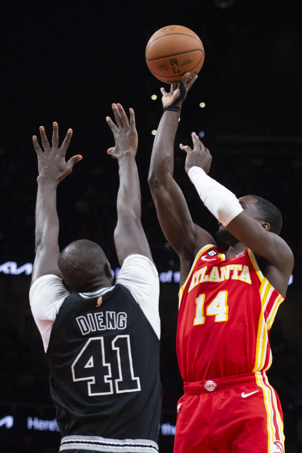 Atlanta Hawks forward AJ Griffin shoots over San Antonio Spurs center Gorgui Dieng during the first half of an NBA basketball game, Saturday, Feb. 11, 2023, in Atlanta. (AP Photo/Hakim Wright Sr.)