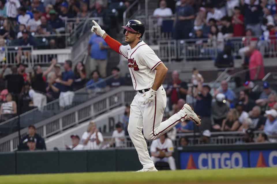 Atlanta Braves' Matt Olson gestures to the crowd as he runs the bases on a solo home run against the Los Angeles Dodgers during the fourth inning of a baseball game Wednesday, May 24, 2023, in Atlanta. (AP Photo/John Bazemore)