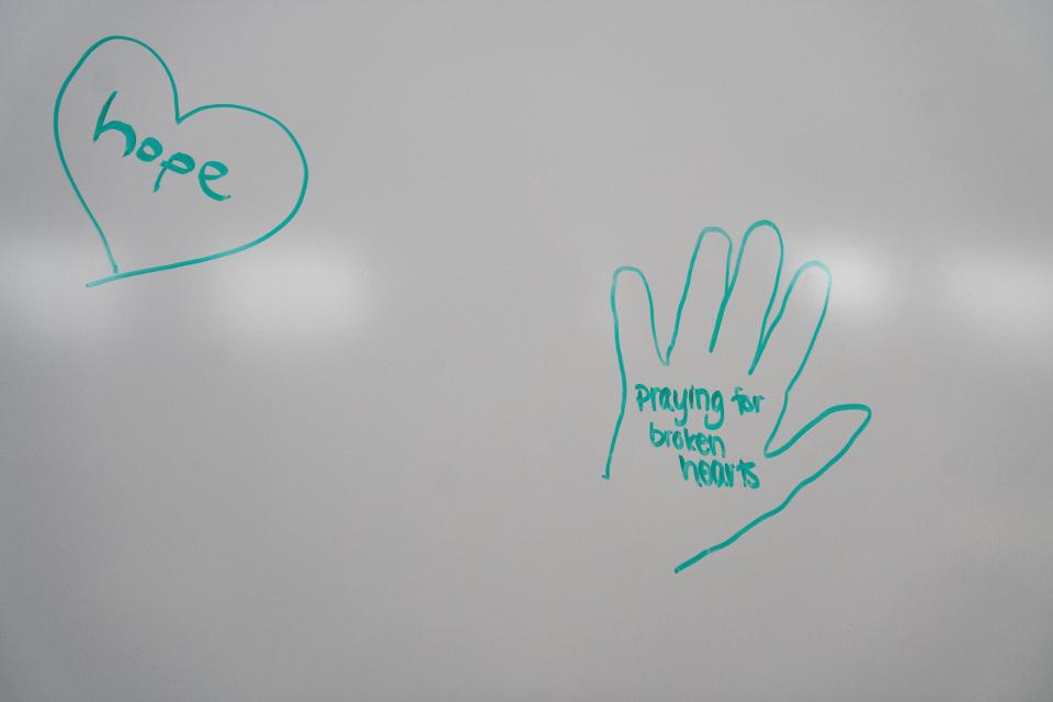 Community members leave notes on the whiteboard as they gather for a community prayer following a shooting at Perry High School Thursday, Jan. 4, 2024, at the Progressive Foundry.