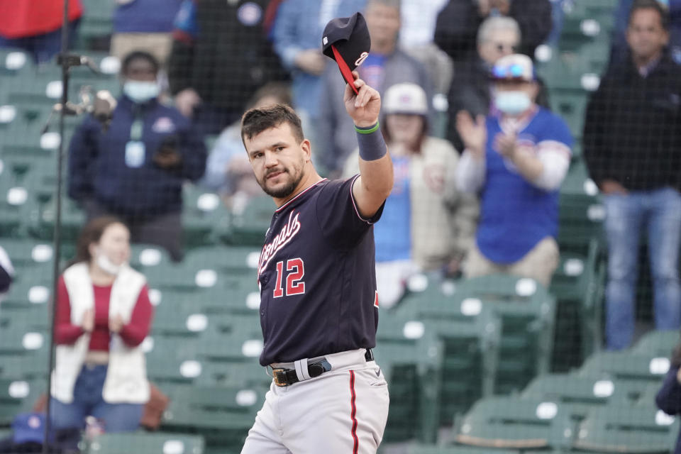 Washington Nationals left fielder Kyle Schwarber (12) tips his cap as the former Cub is honored before a baseball game against the Chicago Cubs, Monday, May, 17, 2021, in Chicago. (AP Photo/David Banks)