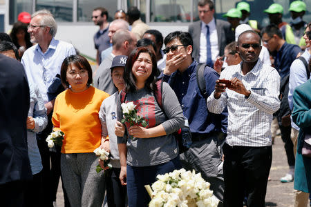 Chinese family and friends mourn victims of the Ethiopian Airlines Flight ET 302 plane crash during a commemoration ceremony at the scene of the crash, near the town of Bishoftu, southeast of Addis Ababa, Ethiopia March 13, 2019. REUTERS/Baz Ratner