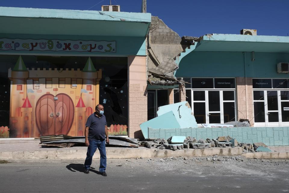 A man stands outside a damaged building after a strong earthquake in Arkalochori village on the southern island of Crete, Greece, Monday, Sept. 27, 2021. A strong earthquake with a preliminary magnitude of 5.8 has struck the southern Greek island of Crete, and Greek authorities say one person has been killed and several more have been injured. (AP Photo/Harry Nikos)