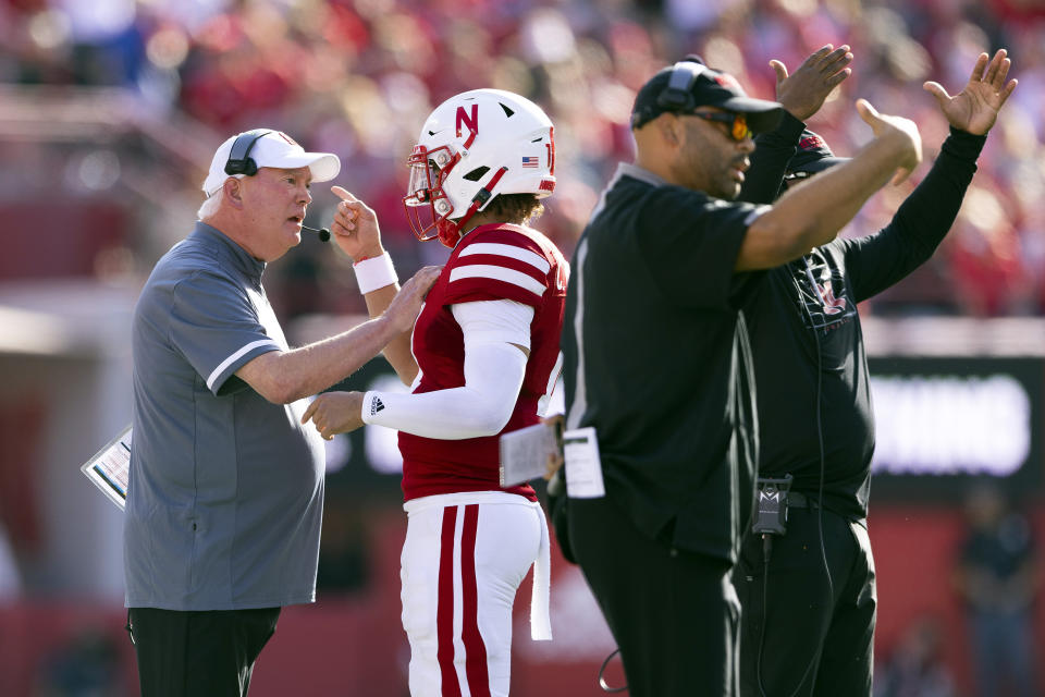 Nebraska offensive coordinator and quarterbacks coach Mark Whipple, left, chats with quarterback Casey Thompson after he threw an interception against Illinois during the first half of an NCAA college football game Saturday, Oct. 29, 2022, in Lincoln, Neb. (AP Photo/Rebecca S. Gratz)
