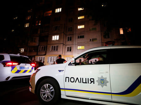 Police cars are seen parked in front of an apartment block where Russian journalist Arkady Babchenko was shot and died of his wounds in an ambulance, in Kiev, Ukraine May 29, 2018. REUTERS/Gleb Garanich