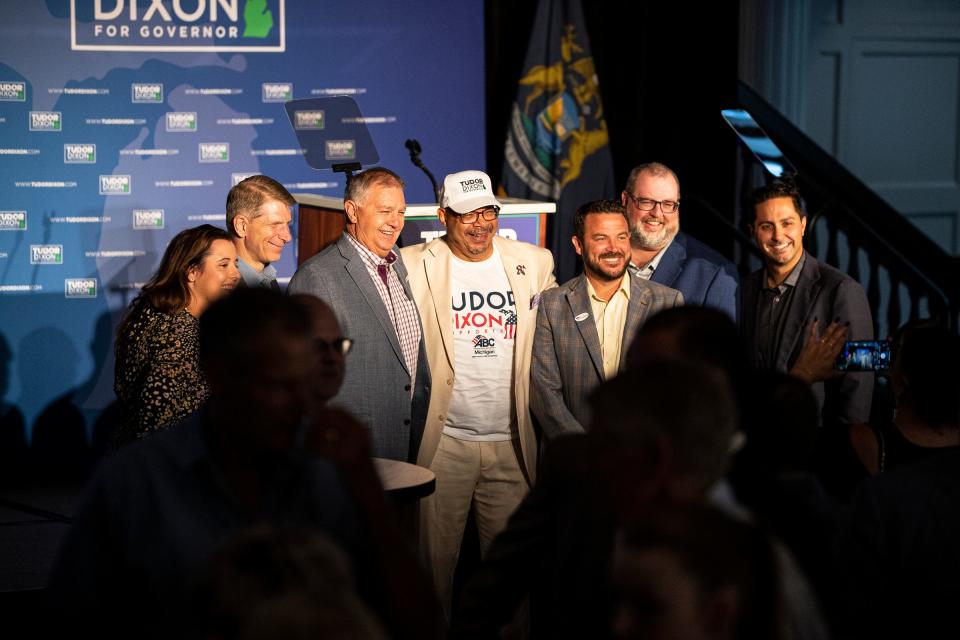 Jimmy Greene, center, president of the Associated Builders and Contractors of Michigan, takes photos with Tudor Dixon supporters as they wait for the primary election result at the watch party for Republican gubernatorial candidate Tudor Dixon at the Amway Grand Plaza Hotel in downtown Grand Rapids on August 2, 2022.