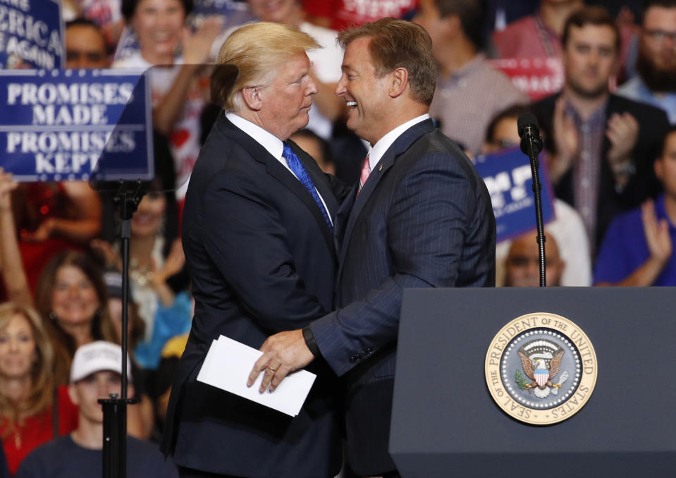 President Donald Trump, left, embraces Sen. Dean Heller, R-Nev., during a campaign rally Thursday, Sept. 20, 2018, in Las Vegas. (AP Photo/John Locher)