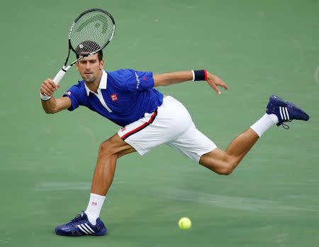 Novak Djokovic of Serbia returns volley to Marin Cilic of Croatia during their men's singles semi-final match at the U.S. Open Championships tennis tournament in New York, September 11, 2015. REUTERS/Carlo Allegri