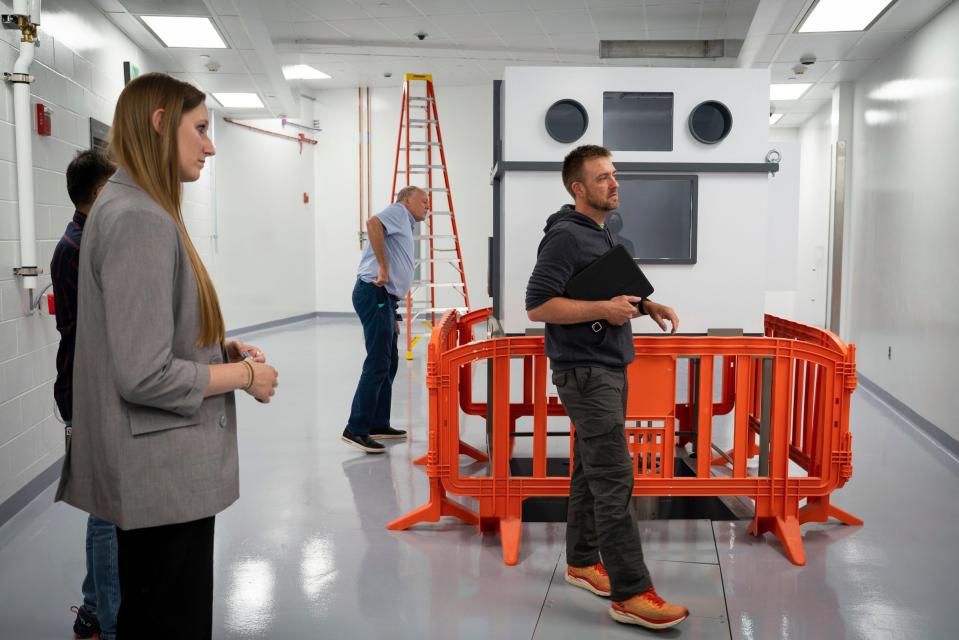 Alyssa Gaiser, assistant professor of chemistry, left, Thomas Glasmacher, FRIB laboratory director, and Greg Severin, associate professor in the chemistry department, show a radiochemistry lab for isotope harvesting inside the Facility for Rare Isotope Beams (FRIB) at Michigan State University in East Lansing on Tuesday, Aug. 1, 2023. In the lab, isotopes from beam dump water are collected and produce purified radioisotopes for different applications such as nuclear astrophysics to nuclear medicine.