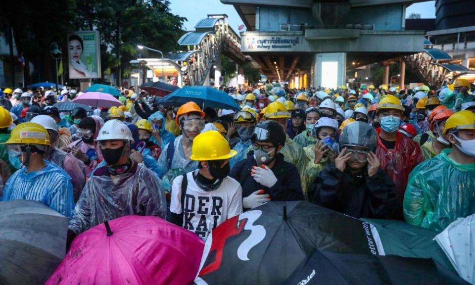 Pro-democracy protesters wearing helmets in Bangkok
