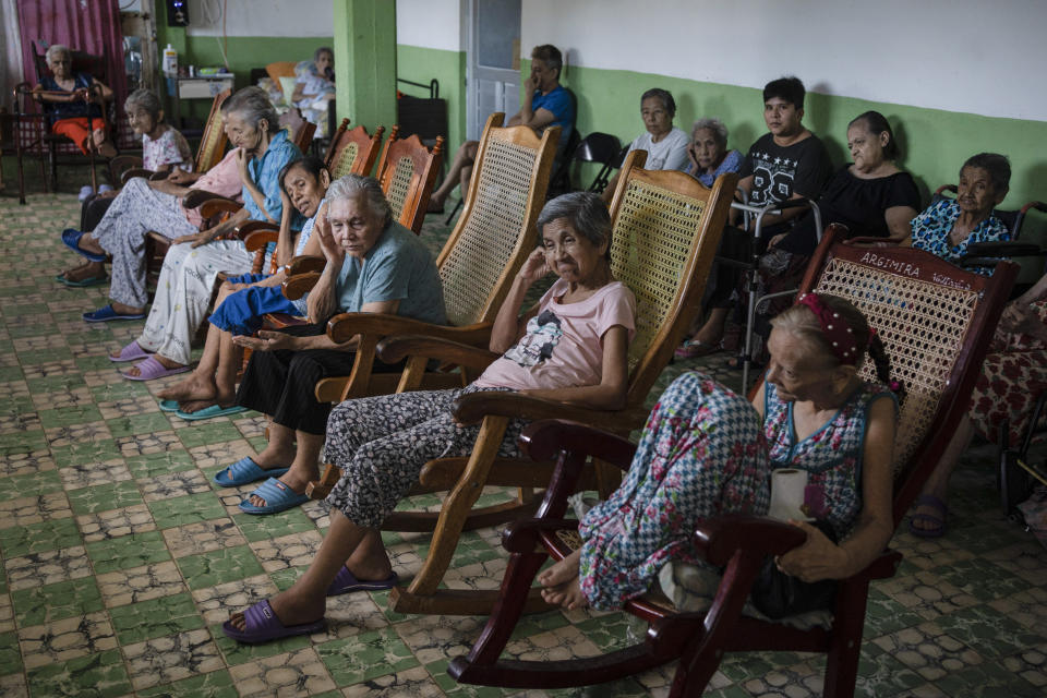 Isabel Rios, 73, center, sits with others by the window of the Cogra nursing home to cool off from the high temperatures in Veracruz, Mexico, Sunday, June 16, 2024. Victims in Veracruz have made up nearly a third of Mexico's heat-related deaths as temperatures have reached 100 degrees in the humid Mexican gulf state. (AP Photo/Felix Marquez)