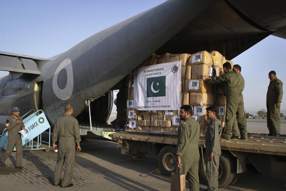 FILE - Pakistan Air Force personnel load humanitarian aid material into a C-130 plane for Ukraine at Nur Khan airbase, in Rawalpindi, Pakistan, on June 3, 2022. When Russian forces two months ago launched a military campaign against infrastructure in Ukraine, it opened an urgent second front far from the contact line: along power lines, water mains, and heating systems, and in places like homes, schools, offices and churches. (AP Photo, File)