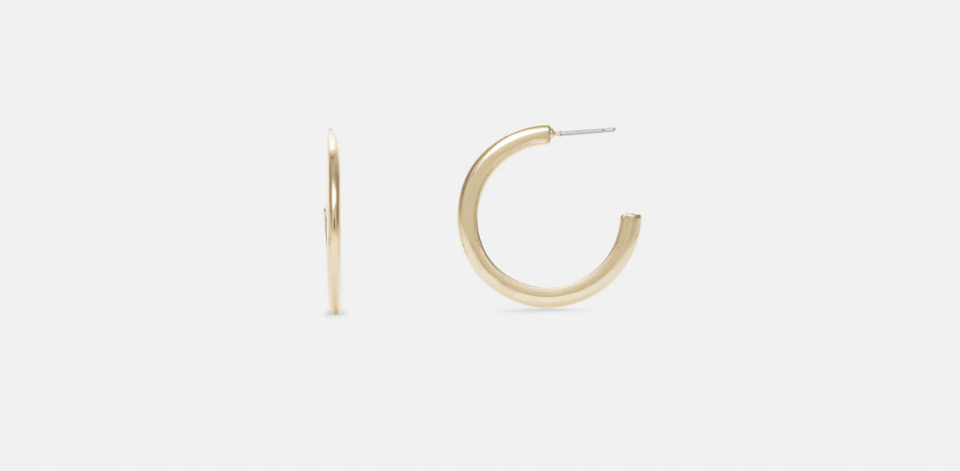 Coach Medium Signature Hoop Earrings in gold (Photo via Coach Outlet)
