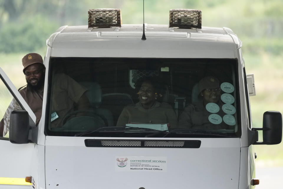 A vehicle, and prison officials leave the Correctional Services prison in Pretoria, South Africa, Friday, Jan. 5, 2024. South African athlete Oscar Pistorius has been released from prison on parole after serving nearly nine years in prison for killing his girlfriend and is now at home, South Africa’s Department of Corrections said Friday. (AP Photo/Themba Hadebe)