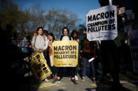 Environmental activists block the entrance of the Ministry of Ecology, Energy and Sustainable Development during a "civil disobedience action" to urge world leaders to act against climate change, in La Defense near Paris, France, April 19, 2019. The slogan reads " Macron, President of polluters". REUTERS/Benoit Tessier