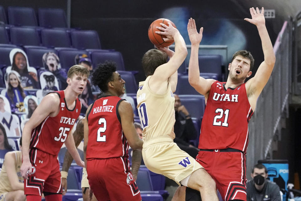 Utah forward Riley Battin (21) reacts as Washington guard Erik Stevenson (10) grabs a rebound during the second half of an NCAA college basketball game, Sunday, Jan. 24, 2021, in Seattle. Washington won 83-79. (AP Photo/Ted S. Warren)