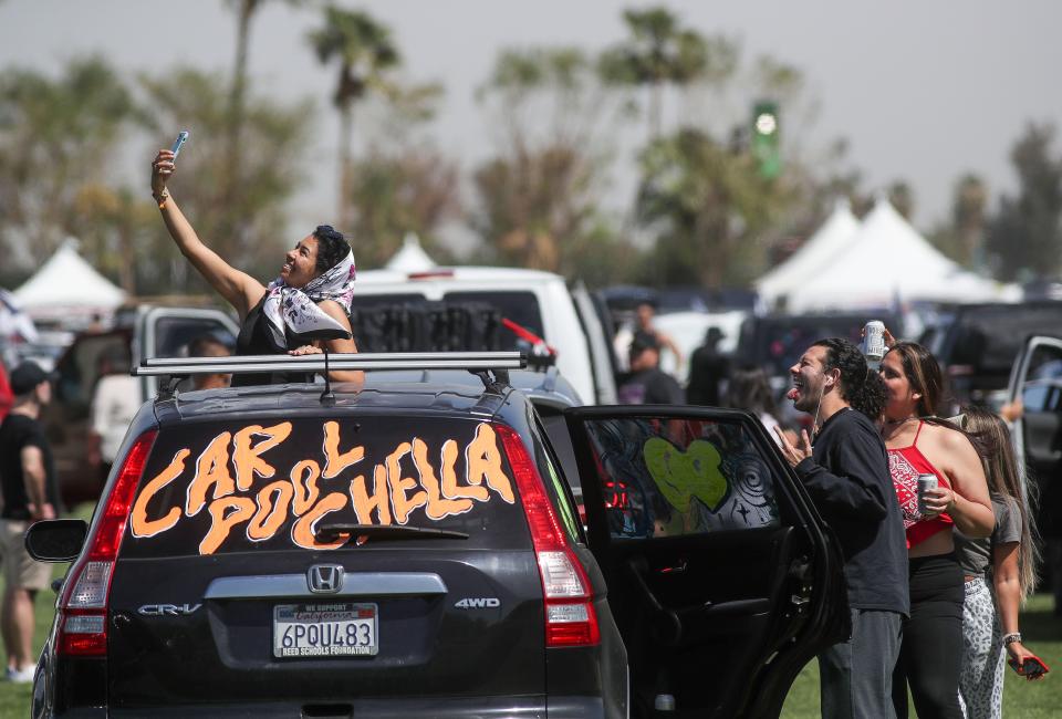 Festivalgoers take a selfie as they wait in the line to their camping spots at the Coachella Valley Music and Arts Festival at the Empire Polo Club in Indio, Calif., Thursday, April 13, 2023.