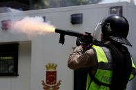 <p>A riot police officer fires tear gas at opposition supporters during a protest against President Nicolas Maduro in Caracas, Venezuela May 4, 2017. (Carlos Garcia Rawlins/Reuters) </p>