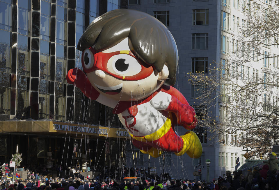 Handlers guide the Red Titan From Ryan's World balloon down Central Park West during the Macy's Thanksgiving Day parade, Thursday, Nov. 23, 2023, in New York. (AP Photo/Jeenah Moon)