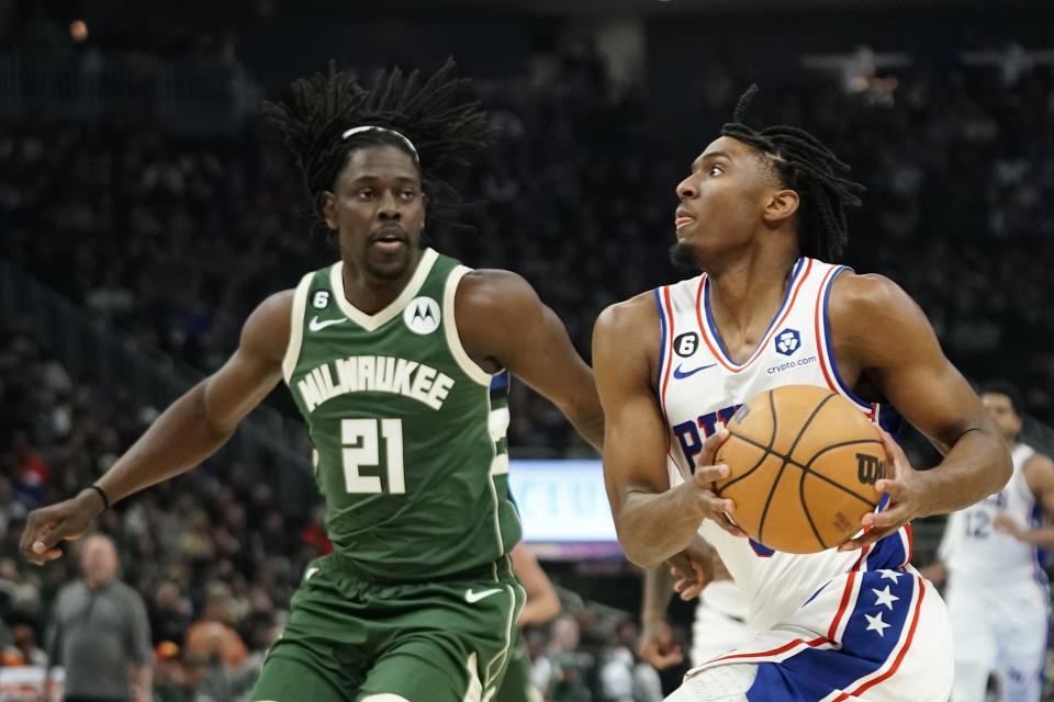 Philadelphia 76ers' Tyrese Maxey, right, drives to the basket against Milwaukee Bucks' Jrue Holiday during the first half of an NBA basketball game Saturday, March 4, 2023, in Milwaukee. (AP Photo/Aaron Gash)