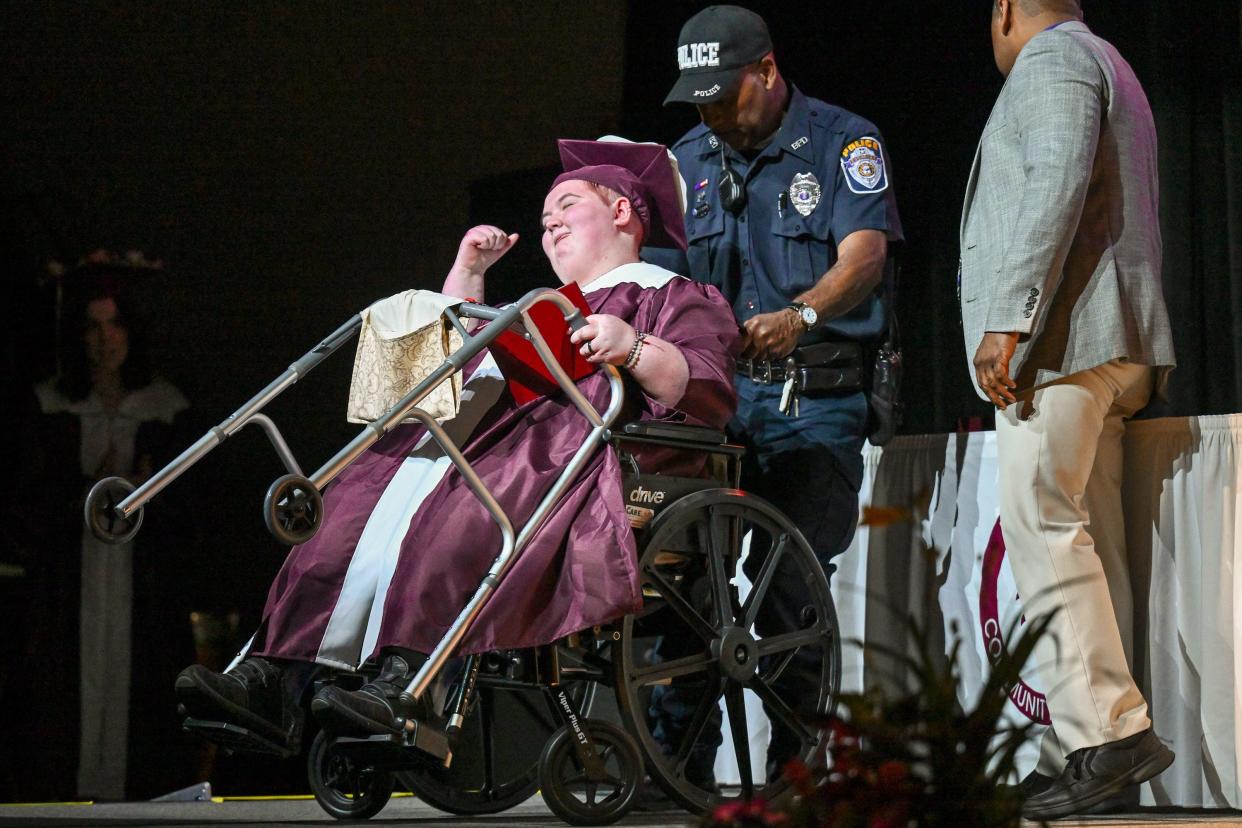 Hannah Blumka reacts after receiving her diploma at the Buchanan High School graduation ceremony May 27 at the school in Michigan. Blumka, now 18, got sick with COVID-19 and spent more than a month in a coma with stays in five hospitals over 156 days.