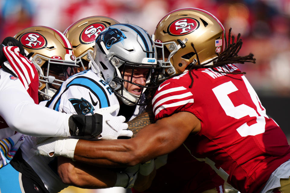 Carolina Panthers running back Christian McCaffrey is tackled by the San Francisco 49ers during the first half an NFL football game on Sunday, Oct. 9, 2022, in Charlotte, N.C. (AP Photo/Jacob Kupferman)